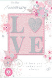 The image shows a romantic anniversary card whose gentle palette and thoughtful details mirror the peaceful character of Pinner's gardens and parks. At its heart, the word LOVE is beautifully rendered in raised, glitter-kissed letters, each stroke shimmering in blush pink with touches of silver that flash softly when the light moves. This embossed centrepiece has a pleasing depth, as if the letters are almost floating above the page, inviting the fingertips to trace their outline with the same care used to cradle a delicate bloom. The surrounding background is a wash of powdery pink and pearly white, diffused like morning light over Pinner Memorial Park, giving the design a soft, dreamlike quality. Around the central word, clusters of stylised blossoms and trailing foliage unfurl across the card, their lines fine and flowing. The flowers, painted in tones of blush, mauve, and ivory, overlap gracefully, creating the impression of a bouquet sketched before stems are cut and arranged. Curving vines, slim leaves, and gently swirling flourishes weave between the petals, adding a rhythmic movement that guides the eye smoothly across the design. Subtle highlights of silver on some blooms and leaves add a refined sparkle without disturbing the card's calm atmosphere. Tucked among the floral motifs, an elegant script message reads On Our Anniversary and I love you today and always, its looping letters echoing the curves of the drawn vines. Overall, the card feels like a paper translation of an anniversary bouquet that might be delivered to a quiet street in Pinner: tender, graceful, and made to be treasured long after the day has passed.